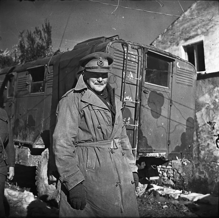 Bernard Cyril Freyberg standing beside truck