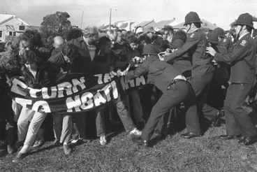 Protestors enveloped in banner 'Return Takaparawhā to Ngāti Whātua Bastion Point Not For Sale' resisting police Image: Protestors enveloped in banner 'Return Takaparawhā to Ngāti Whātua Bastion Point Not For Sale' resisting police