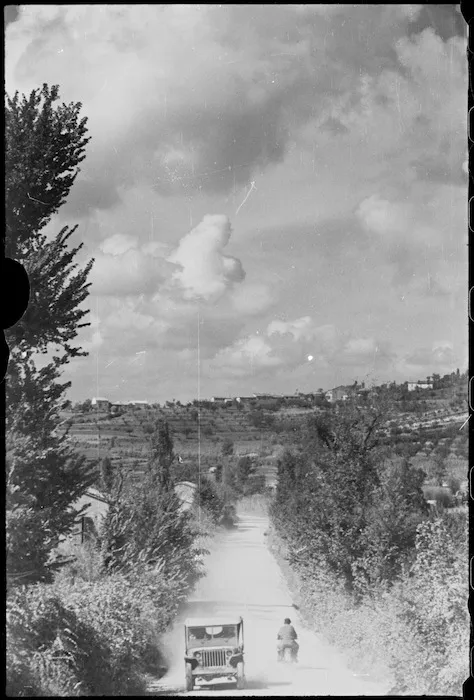 Jeep makes its way along dusty road at Gradara in Italy, World War II - Photograph taken by George Kaye