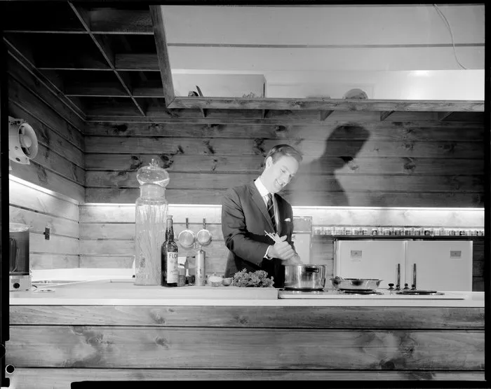 [Studio?] kitchen with a man preparing food, possibly a cooking demonstration