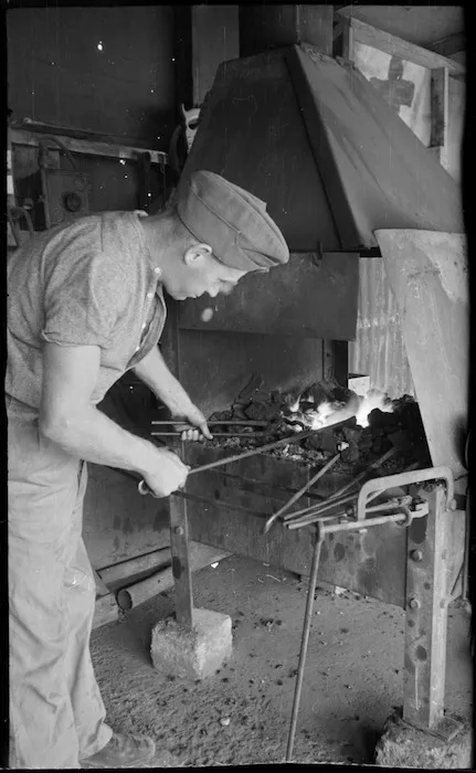 Blacksmith's shop with I R Sutherland working at the forge, Maadi Camp, Egypt - Photograph taken by George Bull