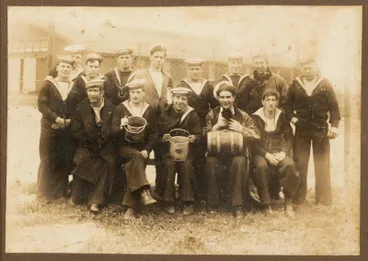 Group of 14 sailors, two hold buckets and a third has a wooden cask on his knees and holds a cat in his hands. The ship name on the sailors' hats is hard to read but is possibly the HMS 'Chatham'. Image: Group of 14 sailors, two hold buckets and a third has a wooden cask on his knees and holds a cat in his hands. The ship name on the sailors' hats is hard to read but is possibly the HMS 'Chatham'.