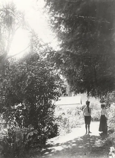 Image: A man and a woman standing in a garden