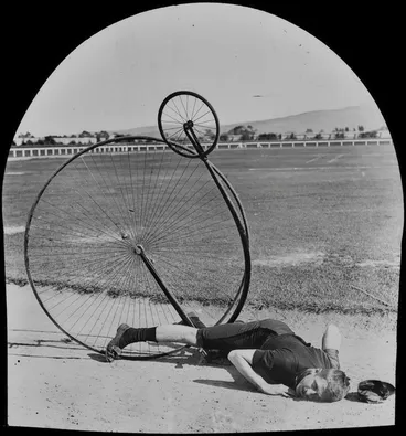 Image: Fred Wood lying on the ground with a penny-farthing