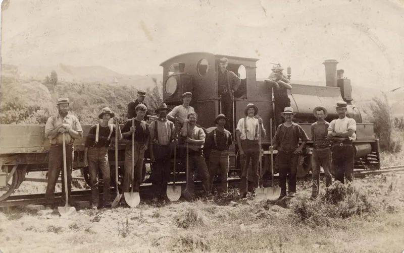 Workmen alongside engine