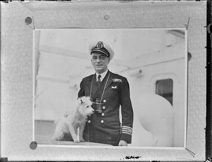 Captain Enright in uniform, Port Phillip, with a small dog