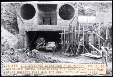 Image: Building the Lyttleton Tunnel. Caption reads: "CA 5331 CHRISTCHURCH-LYTTELTON ROAD TUNNEL: 20: 3: 63 / Lyttelton Portal area; boxing for footing of west Fan- / house support wall and for 2nd. Iift of east wall.".
