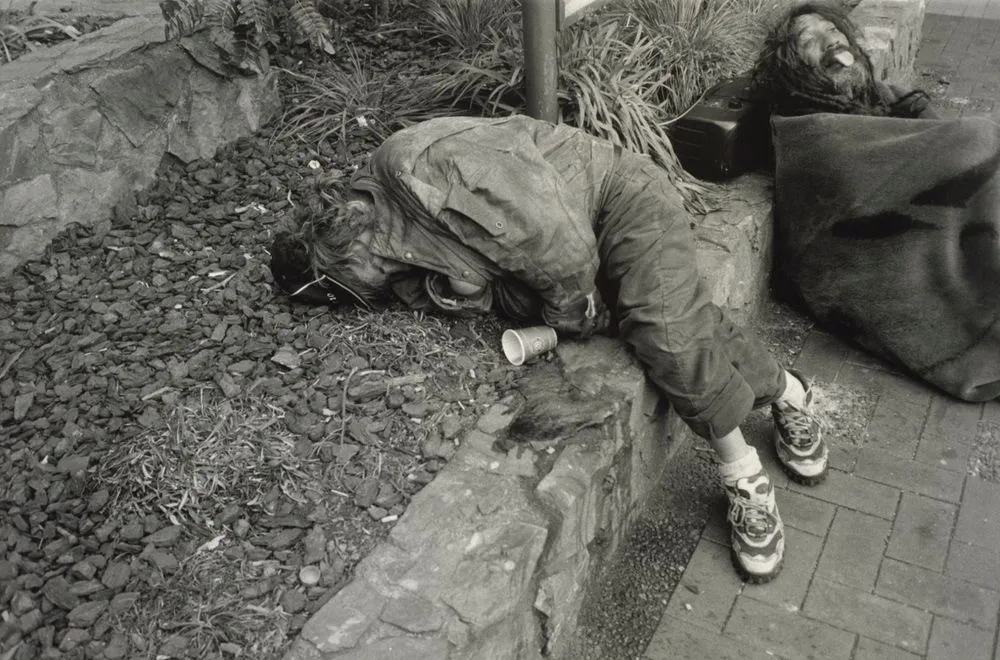Untitled, no.8 (homeless man lying on street garden). From the series: Public