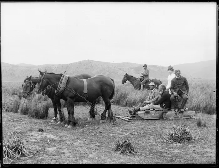 Lydia Williams and unidentified men on a horse-drawn wooden sled, at Whakaki, Wairoa District