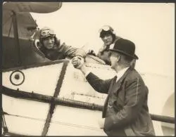 Charles Kingsford Smith and Charles Ulm in cockpit of Bristol Tourer biplane, being met on arrival by Mayor George Baildon at Auckland, New Zealand, September 1928 / Auckland Sun