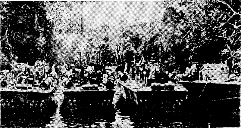Four United States navy patrol torpedo-boats riding at anchor at a jungle river base in the South Pacific. These small but hard-hitting vessels have been remarkably successful against Japanese warships and merchant vessels in the Solomon Islands and elsewhere in ihe Pacific. (Evening Post, 06 December 1943)