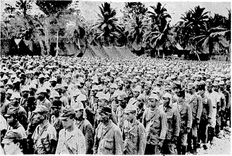 More than 2600 Japanese troops, formerly the garrison on Rota (one of the Mariana Islands, 50 miles north-east of Guam), stand at attention in the prisoner-of-war stockade on Guam. (Evening Post, 01 October 1945)