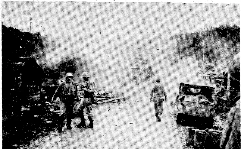 tJ.S. Signal Corps Photo. A Japanese mortar shell has just struck a short distance down the road on the Philippines island of Leyte, injuring three American soldiers, but the veterans of the 32nd Division -were going calmly about • their duties a few seconds later. • (Evening Post, 03 January 1945)