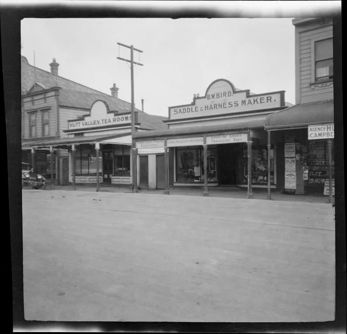 A commercial street in Lower Hutt, showing business premises including Hutt Valley Tea Rooms and B W Bird, Saddle & Harness Maker