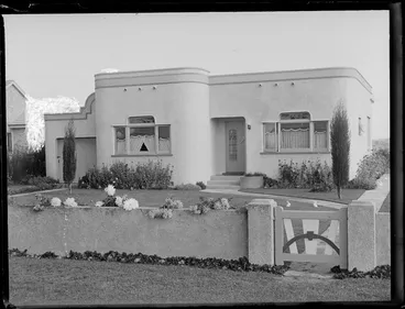 Image: Front view of an Art Deco bungalow and walled garden, location unidentified