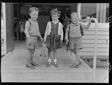 Image: The Hunter triplets standing on classroom steps on their first day of school, Upper Hutt