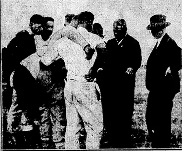 Image: Evening Post" Photo. ■MAORIS IN TRAINING.—Some of the players chosen for the Maori Rugby trial match at Hamilton are shown receiving a lesson in tactics from a famous Maori player of the past, Alec. Takarangi, with Mr. A. C. Kitto (New Zealand Rugby Union representative) an interested i».-..■-. --= ■■■ .•.■•.•■■ ■ •■■ party. ''' :' .'•■■•» (Evening Post, 01 June 1935)