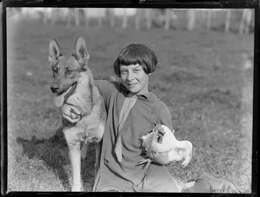 Image: Alsatian dog with hen and child