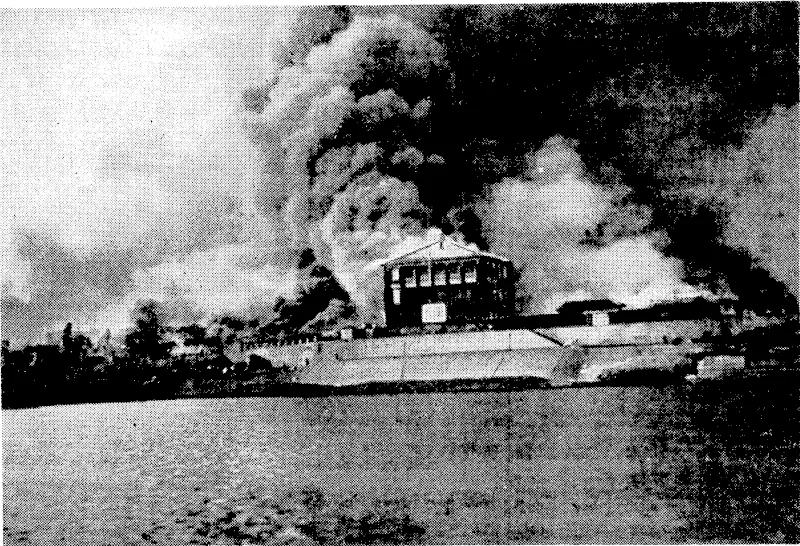 The offices of a British business co ncern on fire in Changsha, capital city of the Hunan Province, China. The fires were started by retreating Chinese soldiers when Japanese troops were approaching to capture the city. (Evening Post, 18 January 1939)