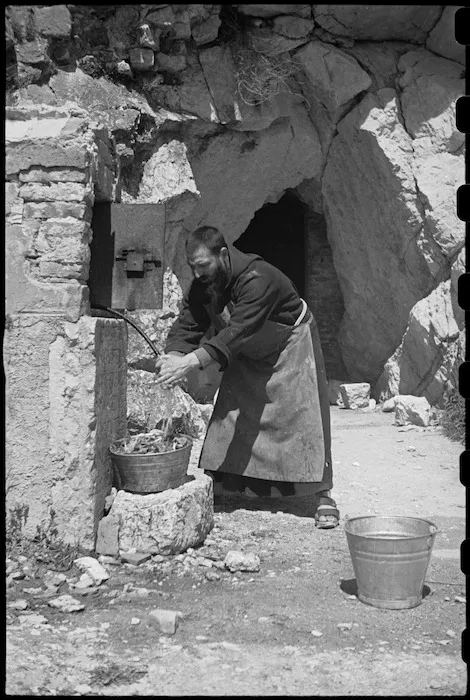 Monk drawing water from ancient cistern in Campobasso, Italy - Photograph taken by George Bull