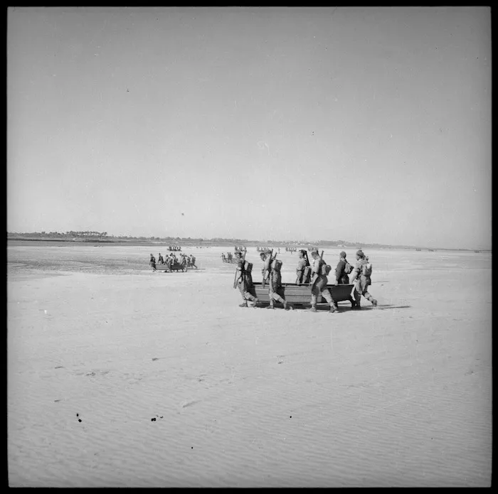 Assault boats carried across sand, Egypt