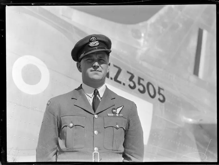 Portrtait of RNZAF Flight Lieutenant AF Jacobsen, W/Opr for survey flight to Japan, at Whenuapai aerodrome, in front of NZ3505 aeroplane