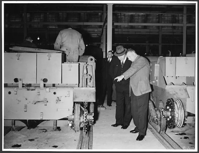 Parliamentary inspection of the production of Bren Gun Carriers at the General Motors plant, Petone, Wellington, during World War II - Photograph taken by the Evening Post