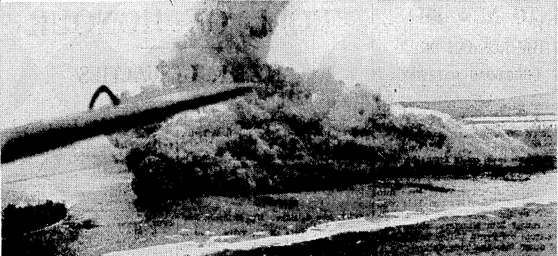 Aerial view of. the explosion of a Japanese ammunition dump, hit by United States aircraft, at the south-east corner of Namur Island, in the Marshalls Group. (Evening Post, 30 March 1944)