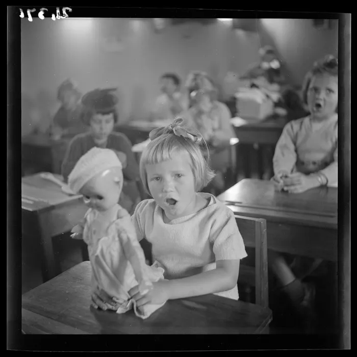 Zofia Portas holds a doll in a classroom at a Polish refugee camp, Pahiatua