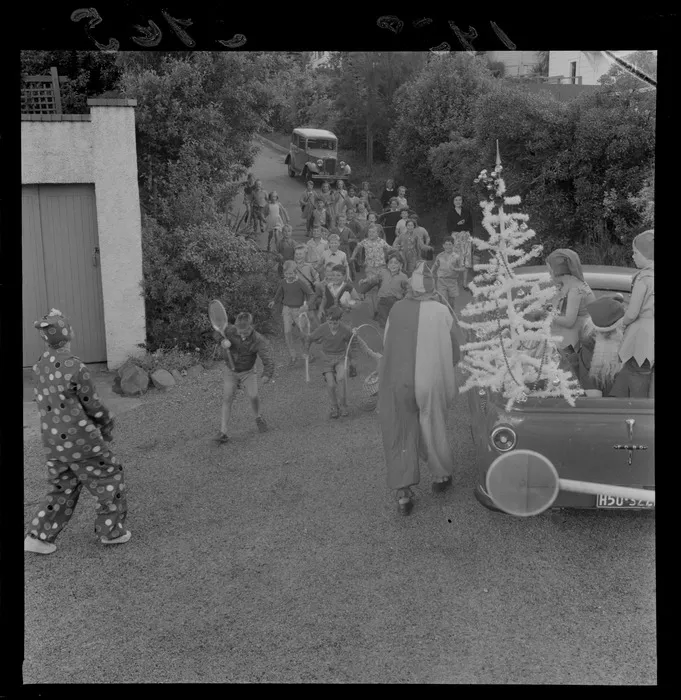 A Santa Claus and a clown visiting children