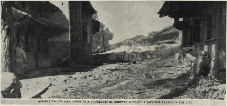 Assault troops seek cover as a Chinese flame-thrower attacks a Japanese pillbox in the city