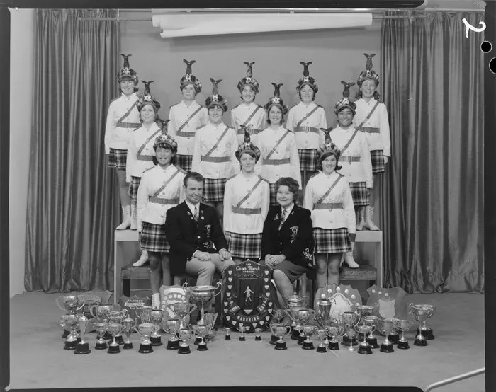 Weldonettes marching team with numerous cups and shields including New Zealand Marching Association Quick March Trophy