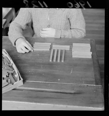 Image: Cuisenaire rods laid on a desk demonstrating the 'strip' method of learning arithmetic, probably Wellington region