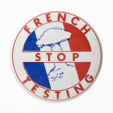 Image: Badge - Stop French Testing, circa 1983