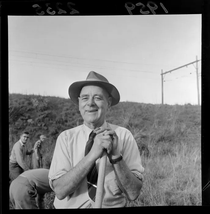 A group planting trees on a railway embankment, featuring an unidentified man, Wellington region