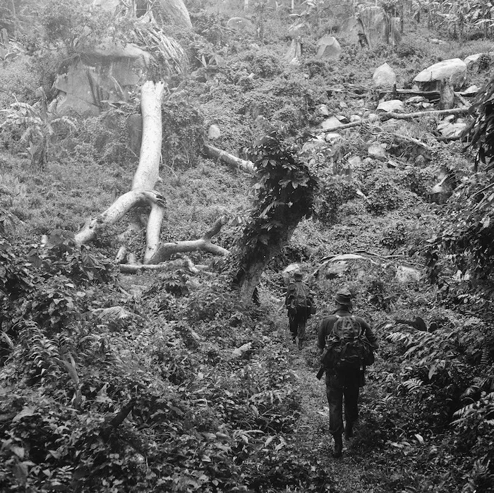 On patrol in pouring rain, Malayan jungle