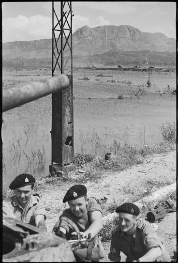 Image: Men working on salvaged tank near flooded flats of Cassino, Italy, World War II - Photograph taken by George Kaye