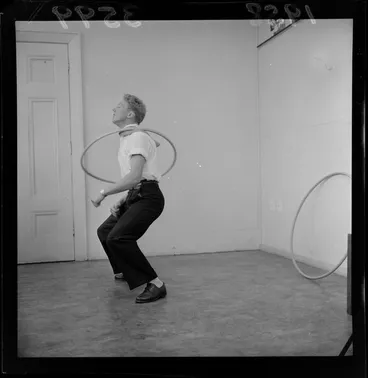 Image: Mr C Matthews, demonstrating a Hula hoop, unknown location