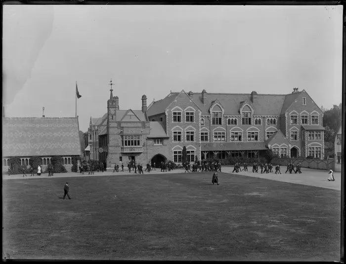 Quadrangle and buildings at Christ's College, Christchurch, including School House and Big School, with students and masters walking through grounds