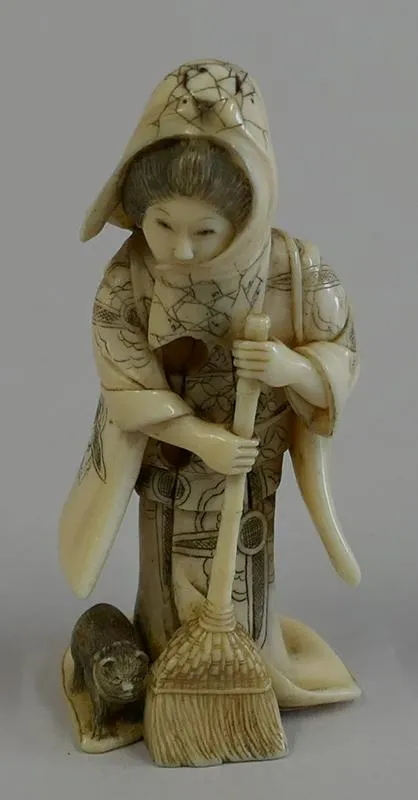 Okimono: Zashik Joji no Onna [A Woman Sweeping a Room]; Standing woman with a broom and a cat.