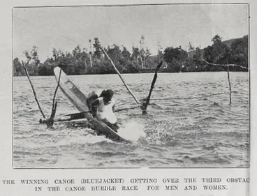 Image: The winning canoe, Bluejacket, getting over the third obstacle in the canoe hurdle race for men and women