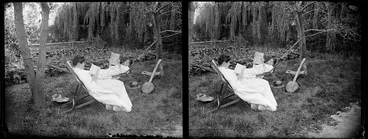 Image: Lydia Myrtle Williams (in hammock) and an unidentified woman in a chair, both of whom are reading, in the garden at the Williams' Carlyle Street home, Napier, Hawkes Bay Region, with vegetable garden in the background