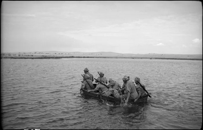 Assault party travels across the water in assault boat, Egypt