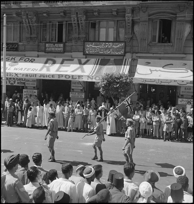 Standard bearer with New Zealand flag leads NZ representatives in the United Nations Day Parade, Cairo - Photograph taken by M D Elias