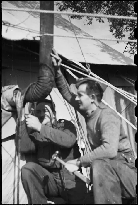 Staff of NZ Reinforcement Unit installing a stove in their tent, Italian 5th Army Front, World War II - Photograph taken by George Bull