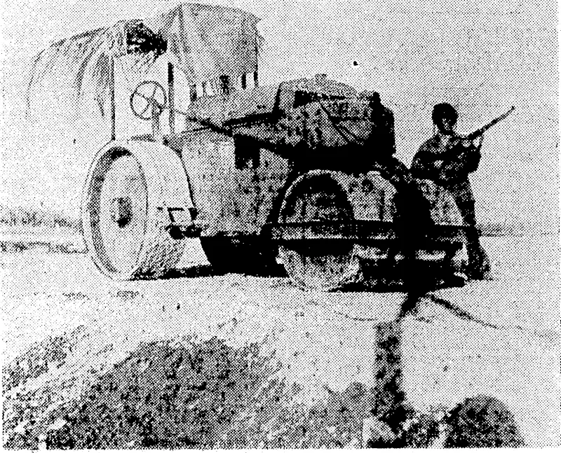 A road roller guarded by an American marine on Guadalcanar Island. It was taken there by the Japanese for use in the construction of an . X airport. ■■ (Evening Post, 08 October 1942)