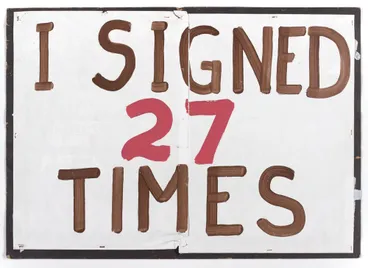 Image: 'I signed 27 times' placard