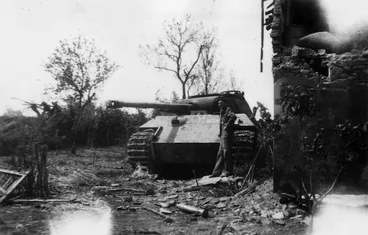 Image: Bill Guest standing by a Panther tank, Italy