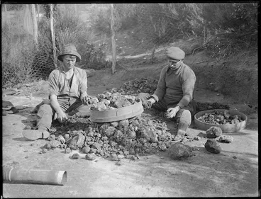 Image: Two gum diggers sorting kauri gum, Northland