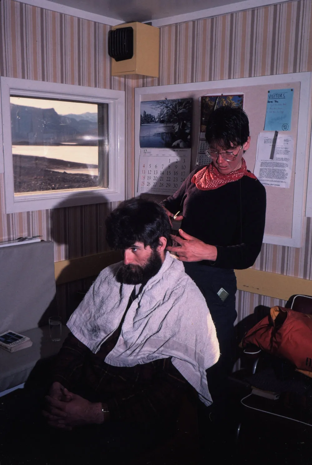 Malcolm Macfarlane getting haircut from Japanese Scientist